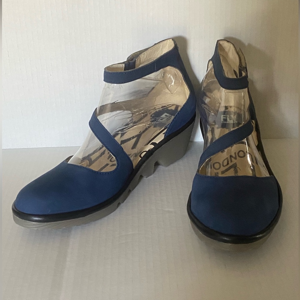 Fly London Cupido leather closed toe wedge with Velcro closure and cross strap.